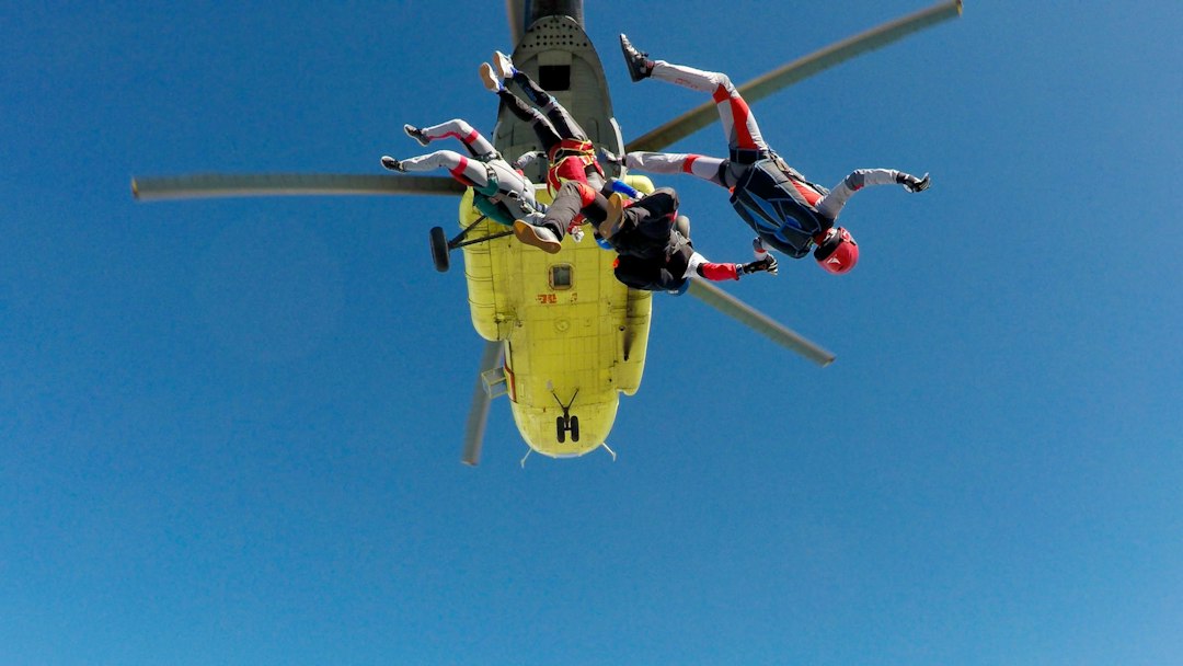 three skydiving people