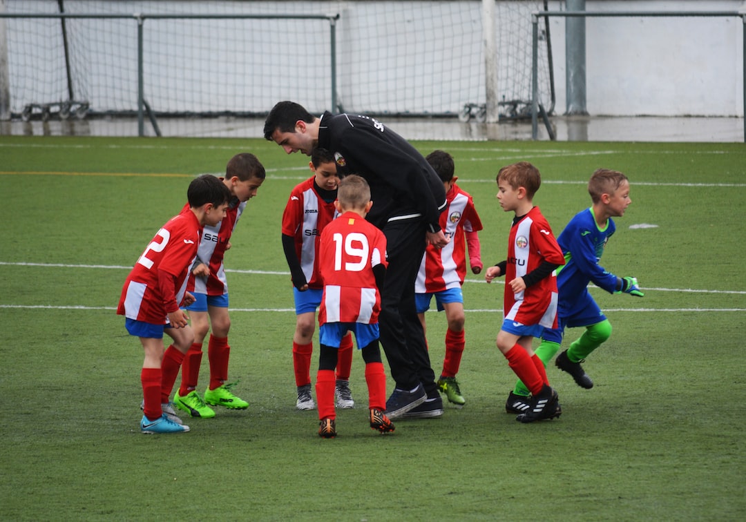 Football coach by MMA Ninja children playing soccer