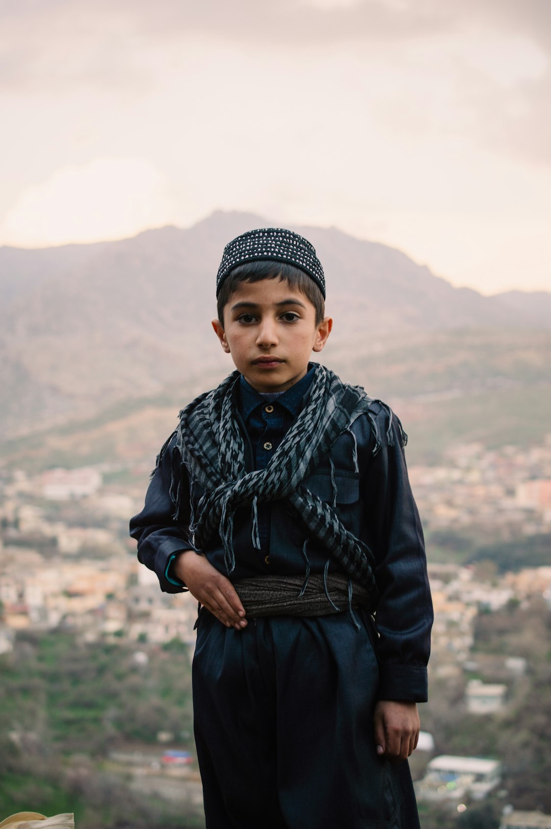 Kurdish child wearing Kurdish clothes in Akre. by MMA Ninja boy in black leather jacket and black knit cap